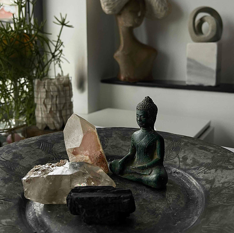 Buddha and crystals on copper tray