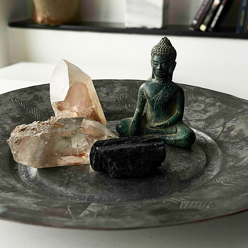 Buddha and crystals on copper tray