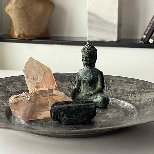 Buddha and crystals on copper tray